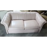 An Emerson pale pink leather two-seater settee, 66” long.
