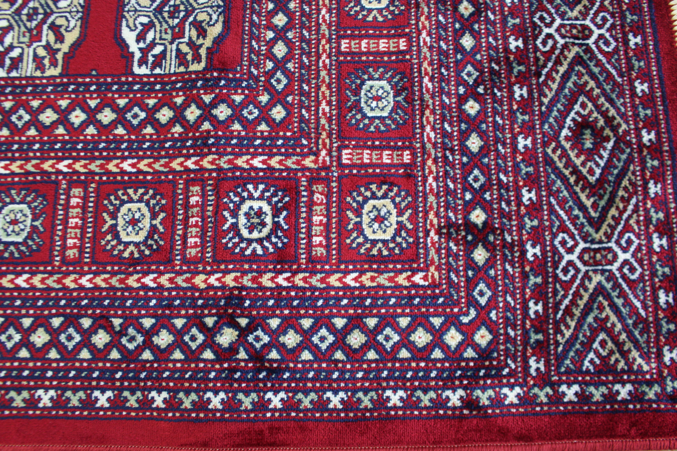 A Bokhara carpet of crimson ground & with seven rows of nineteen guhls to centre within a multiple - Image 2 of 3