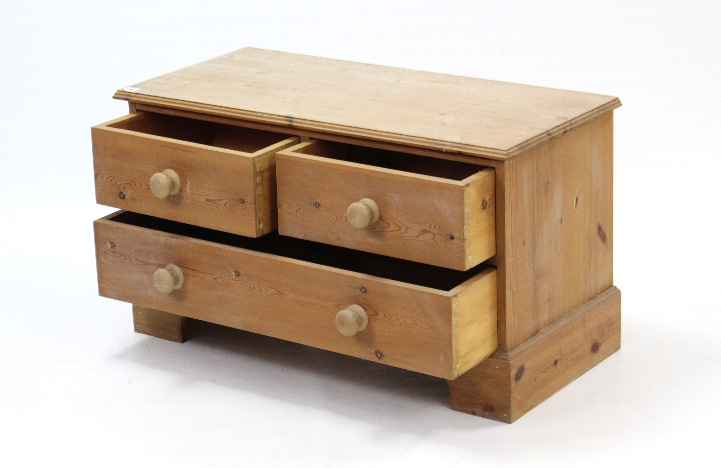 A pine dwarf chest fitted two short & one long drawer with turned knob handles, & on shaped plinth - Image 2 of 2