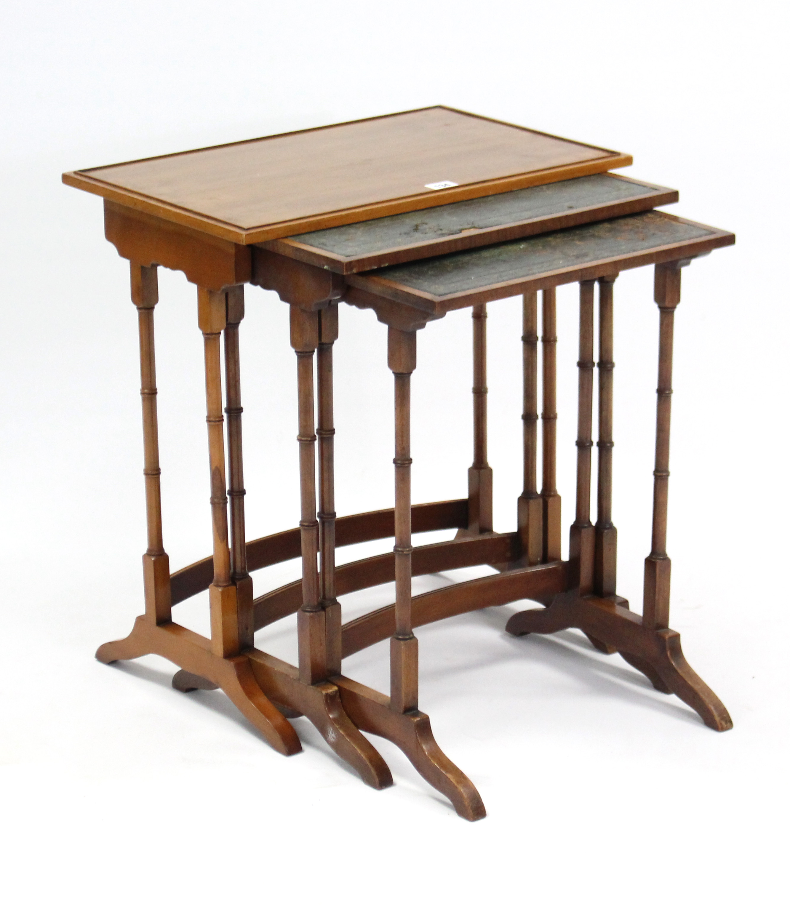 A yew wood nest of three rectangular occasional tables, each table on four-spider-turned legs.