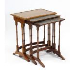 A yew wood nest of three rectangular occasional tables, each table on four-spider-turned legs.