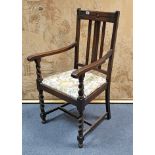 A 1930’s oak carver chair with padded drop-in-seat, & on barley-twist legs with plain stretchers;