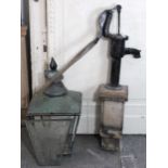 A black painted cast-iron water pump mounted on wooden base, 49” high (overall); together with a