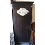 An Edwardian oak wardrobe with moulded cornice, enclosed by centre panel door, & on ball feet, 33”