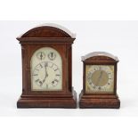 An early 20th century mantel clock with silvered dial, chiming movement, & in inlaid-mahogany