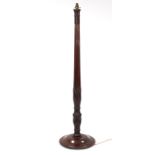 A carved mahogany standard lamp on circular base, complete with shade.