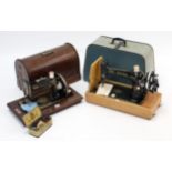 An Atlas hand sewing machine; & a Singer ditto, each with carrying case.