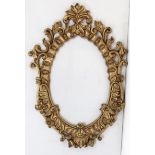 A 19th century-style gilt composition frame oval picture frame, with scroll border, 53½” x 40”.