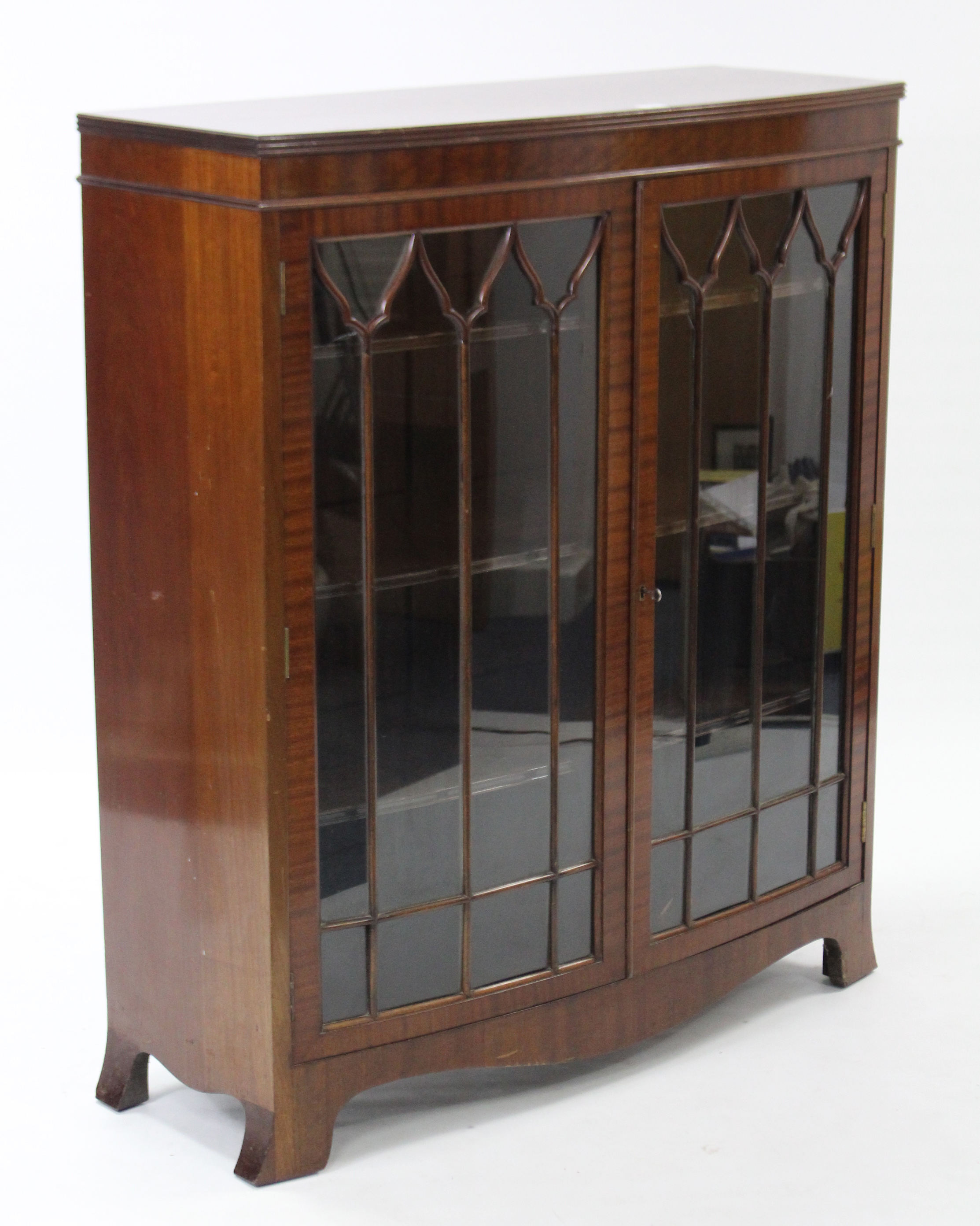 An Edwardian mahogany bow-front china display cabinet, with three adjustable shelves enclosed by