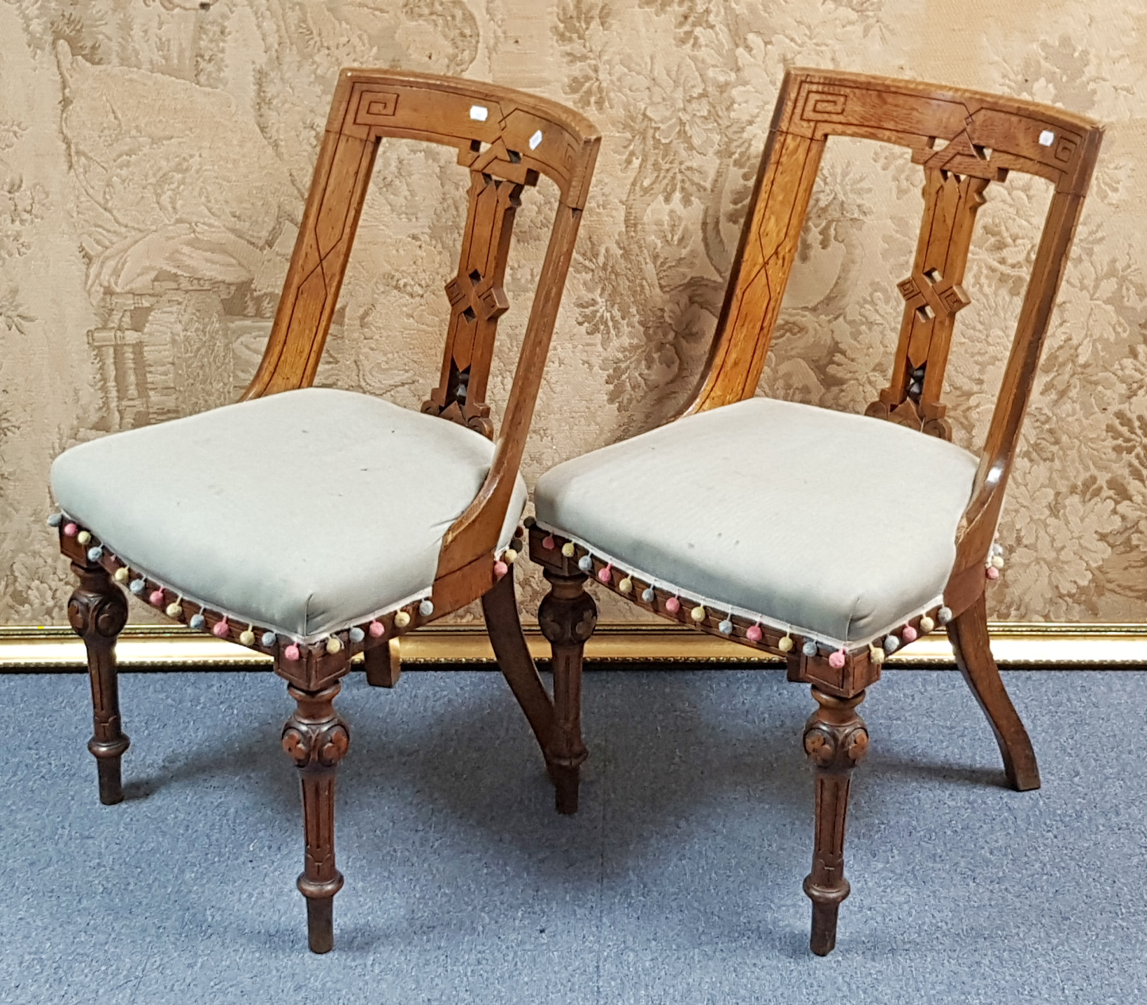 A set of six late Victorian carved oak Athenian-style dining chairs with pierced splat backs, padded