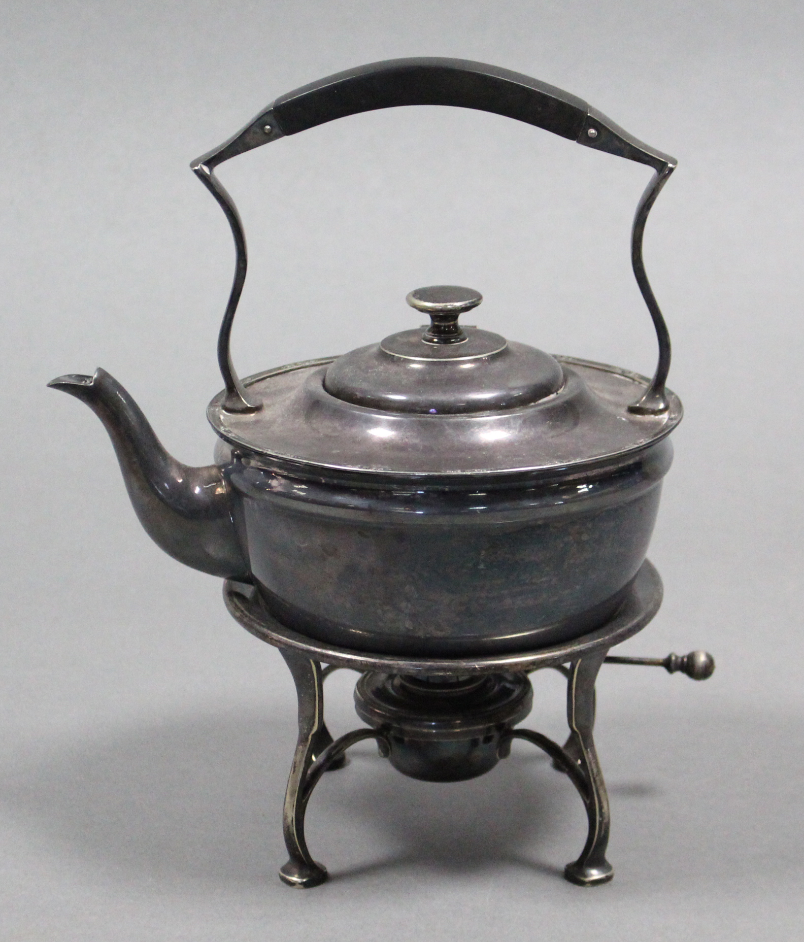 A plain round tea kettle on spirit burner stand; 10½” high.
