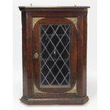 A 19th century oak hanging corner cabinet fitted two shelves enclosed by leaded glazed door, 28”