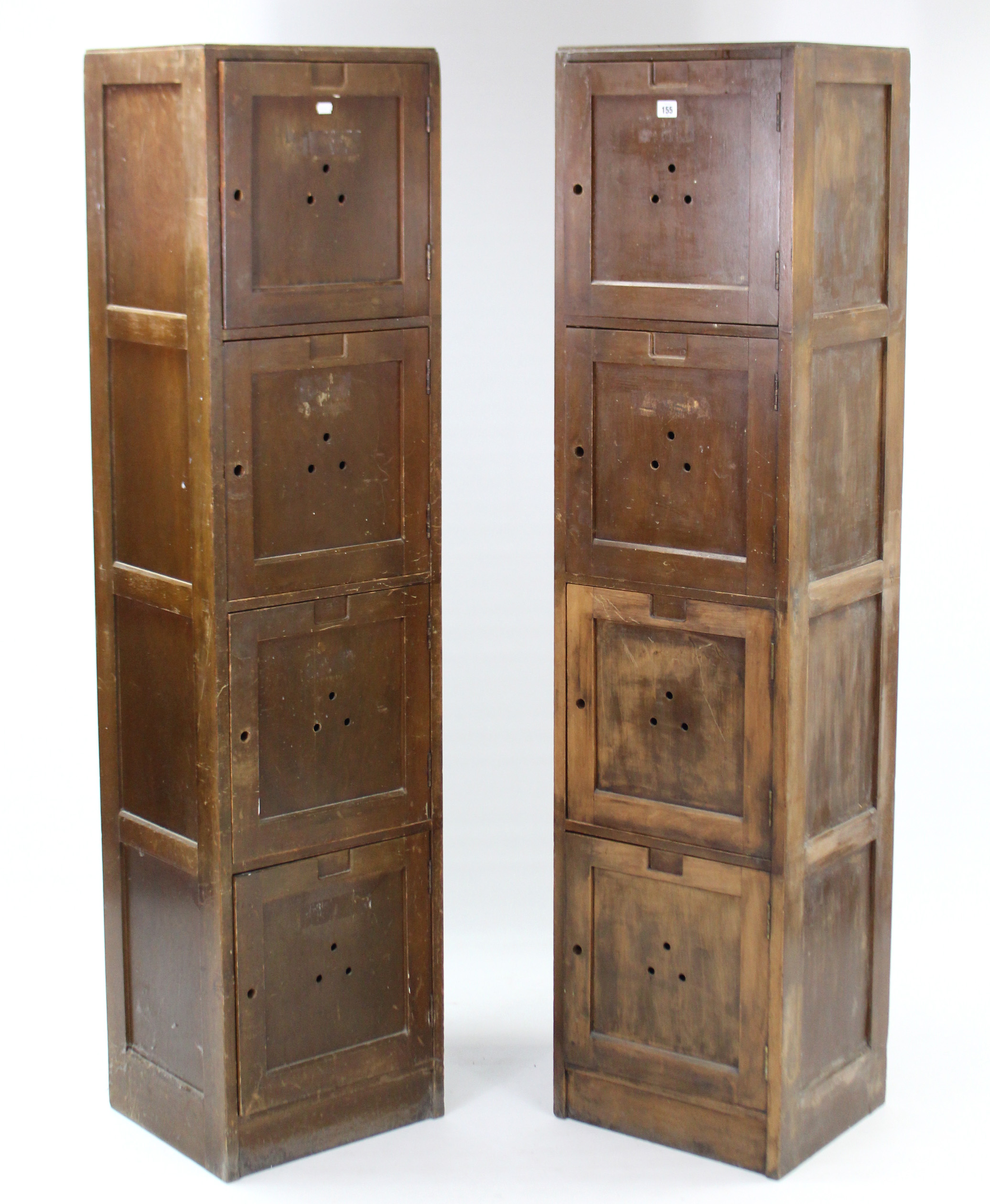 A pair of plywood tall lockers, each enclosed by four panel doors, 15¾” wide x 64¾” high.