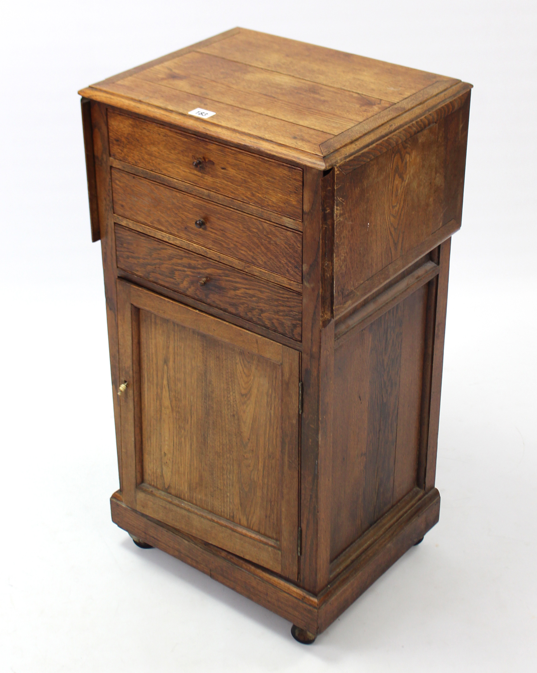 An early 20th century oak drop-leaf bedside cabinet fitted three long drawers above cupboard - Image 6 of 6