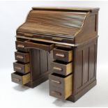 An early-mid 20th century oak Lebus roll-top desk, with fitted interior enclosed by tambour shutter,