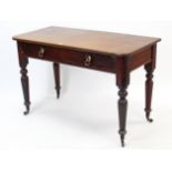 A Victorian mahogany side table with rounded corners to the rectangular top, fitted two frieze