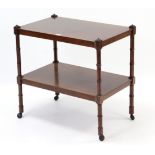 A mahogany rectangular two-tier tea trolley on turned supports, 27” wide; together with three wall
