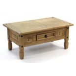 A pine rectangular low coffee table, fitted centre frieze drawer & on short square legs, 39½” wide.