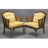 A pair of beech-frame armchairs, with shaped backs & inset woven cane panels to the open arms,