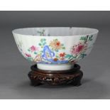 An 18th century Chinese famille rose fluted punch bowl, painted with a formal flower garden & rock-