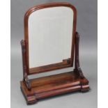 A mid-Victorian mahogany large swing toilet glass with carved supports, on inverted break-front base