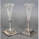 A pair of Edwardian cut glass posy vases on square silver bases, 7¾” high; Sheffield 1898 by