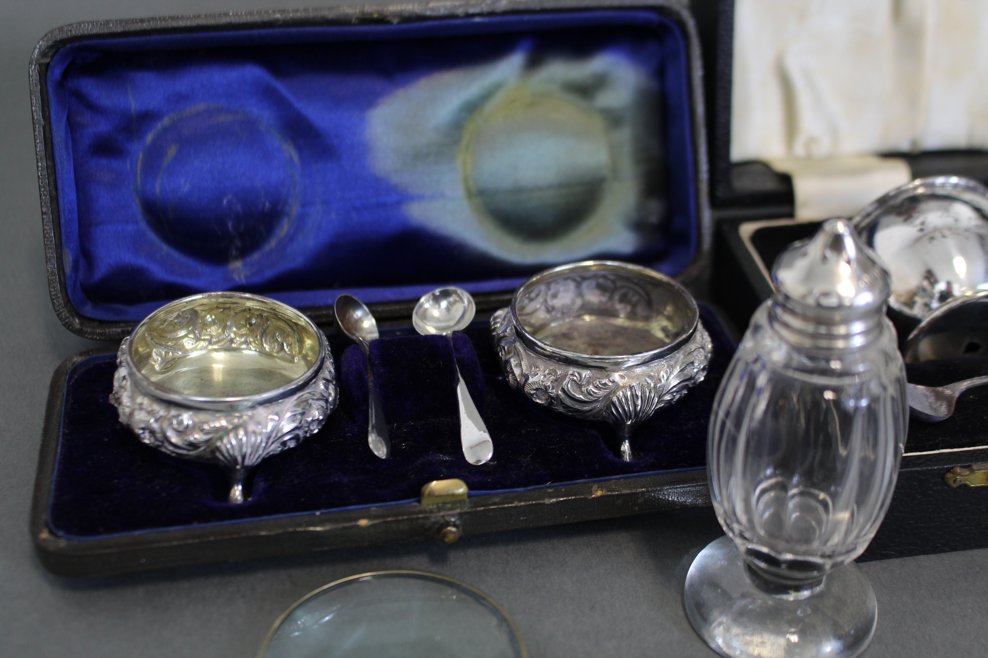 A pair of silver circular salt cellars with embossed shell & scroll decoration, each on three pad - Image 2 of 3