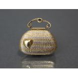 A three-colour gold locket in the form of a ladies’ evening bag, the textured surface with