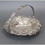 An early Victorian silver circular cake basket with wide floral-embossed & pierced border, pierced