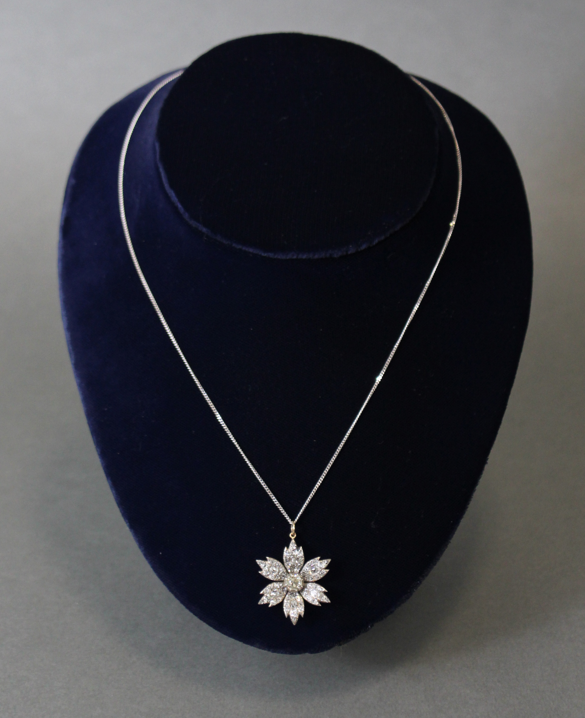 A DIAMOND FLOWER-HEAD PENDANT, the centre stone approximately 0.5 carat, surrounded by six petals - Image 3 of 5