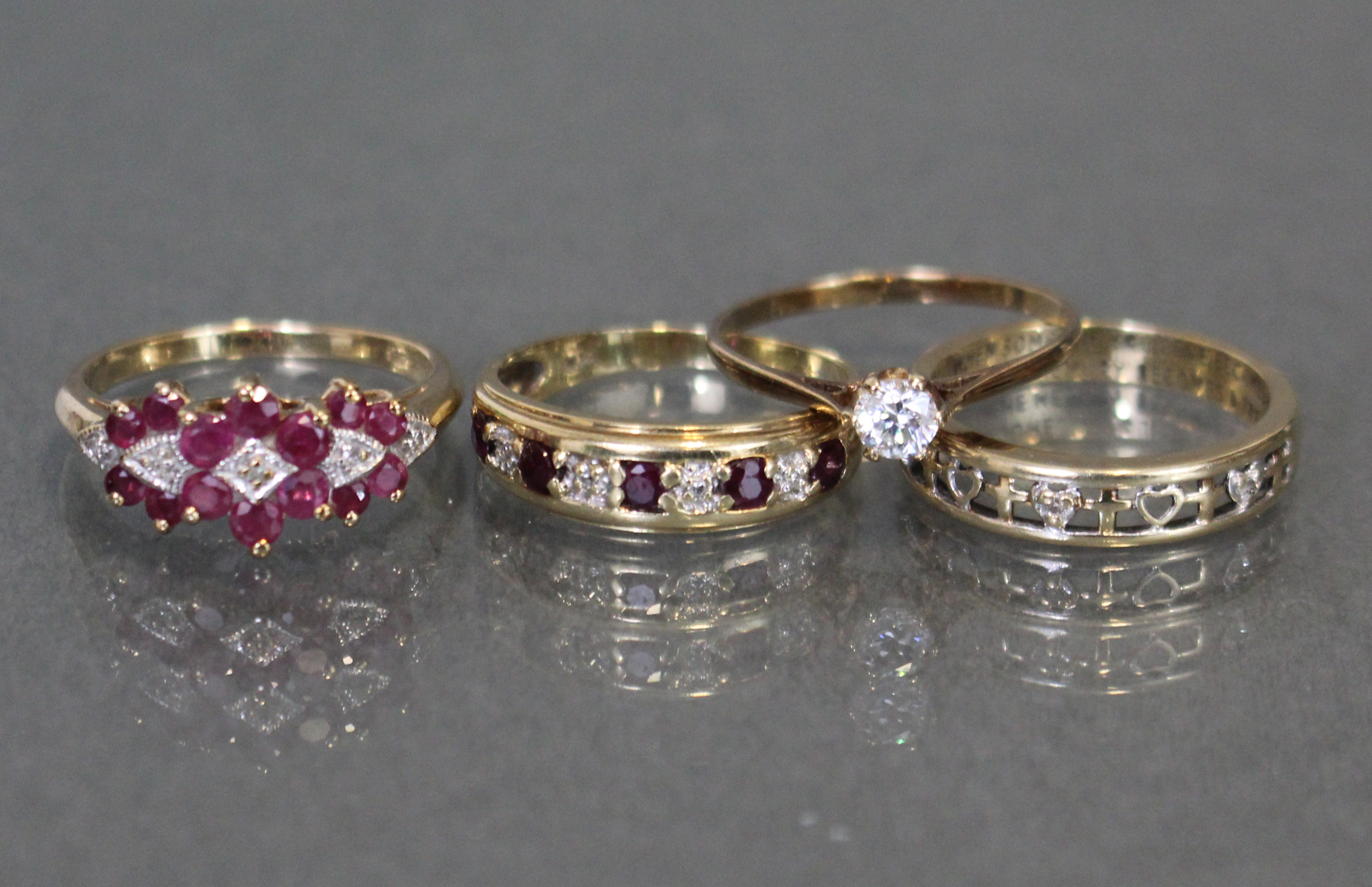 Three various 9ct. gold gem-set rings; & a simulated diamond solitaire.