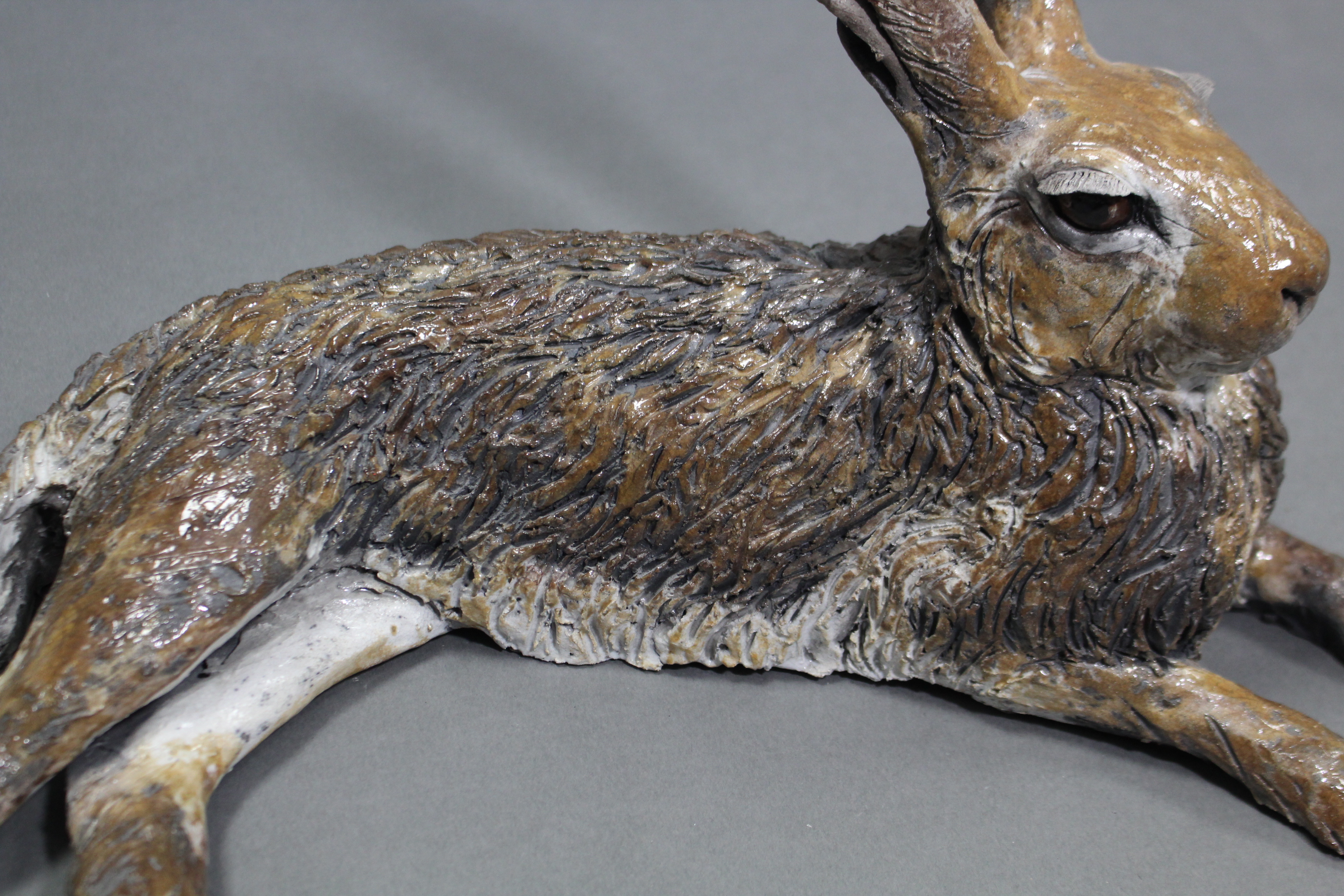 NICK MACKMAN; a contemporary ceramic sculpture titled: “Lying Down Hare”, glazed in naturalistic - Image 3 of 5