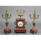A 19th century French rouge marble clock garniture, the mantel clock with 3½” white enamel dial with