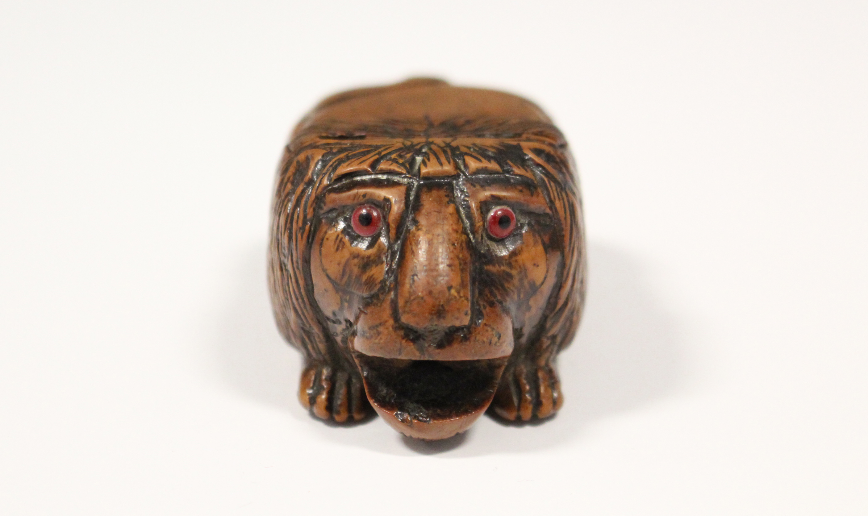 A 19th century coquilla-nut snuff box carved in the form of a crouching lion, with inset glass - Image 2 of 6