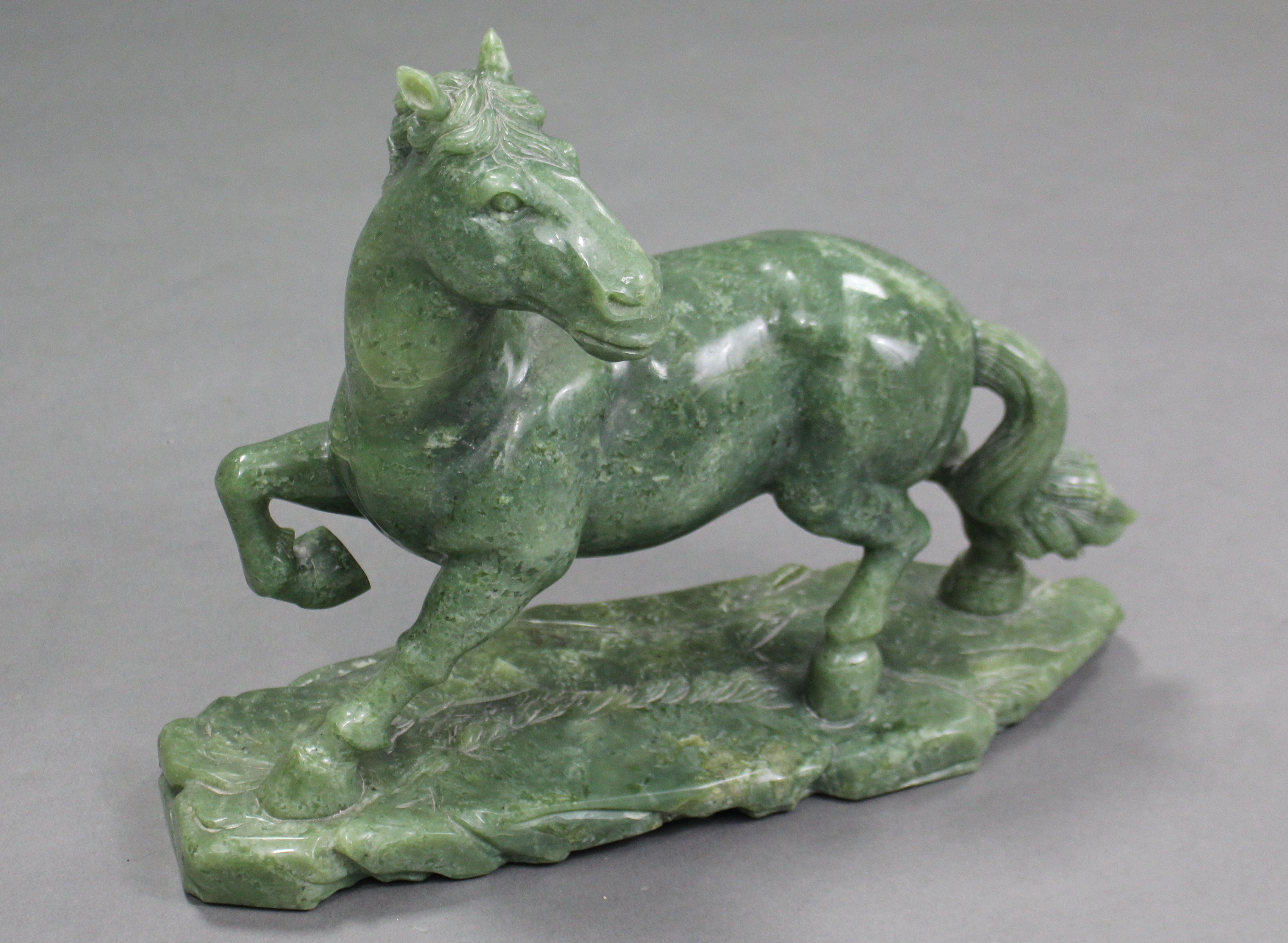 A LARGE CARVED GREEN JADE-ITE MODEL OF A HORSE, its right leg raised & head turned to the left, with - Image 2 of 4