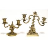 A 19th century French ormolu twin-branch candelabrum with foliate scroll arms & flower-finial on