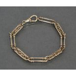 A 9ct. gold flexible bracelet of alternating fancy elongated links; 7¾” long. (10.7gm).