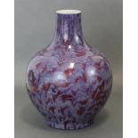 A Chinese porcelain bottle vase, with red-ground “flambé”-type glaze; 12¼” high. (The neck reduced