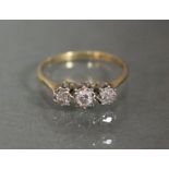 An 18ct. gold ring set three small diamonds.