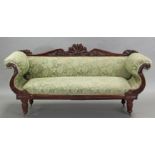 A Victorian carved mahogany frame three-seater sofa with anthemion surmount, scroll ends & on fluted