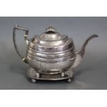 A George III silver oblong teapot & stand, each with engraved decoration & initials, on four ball