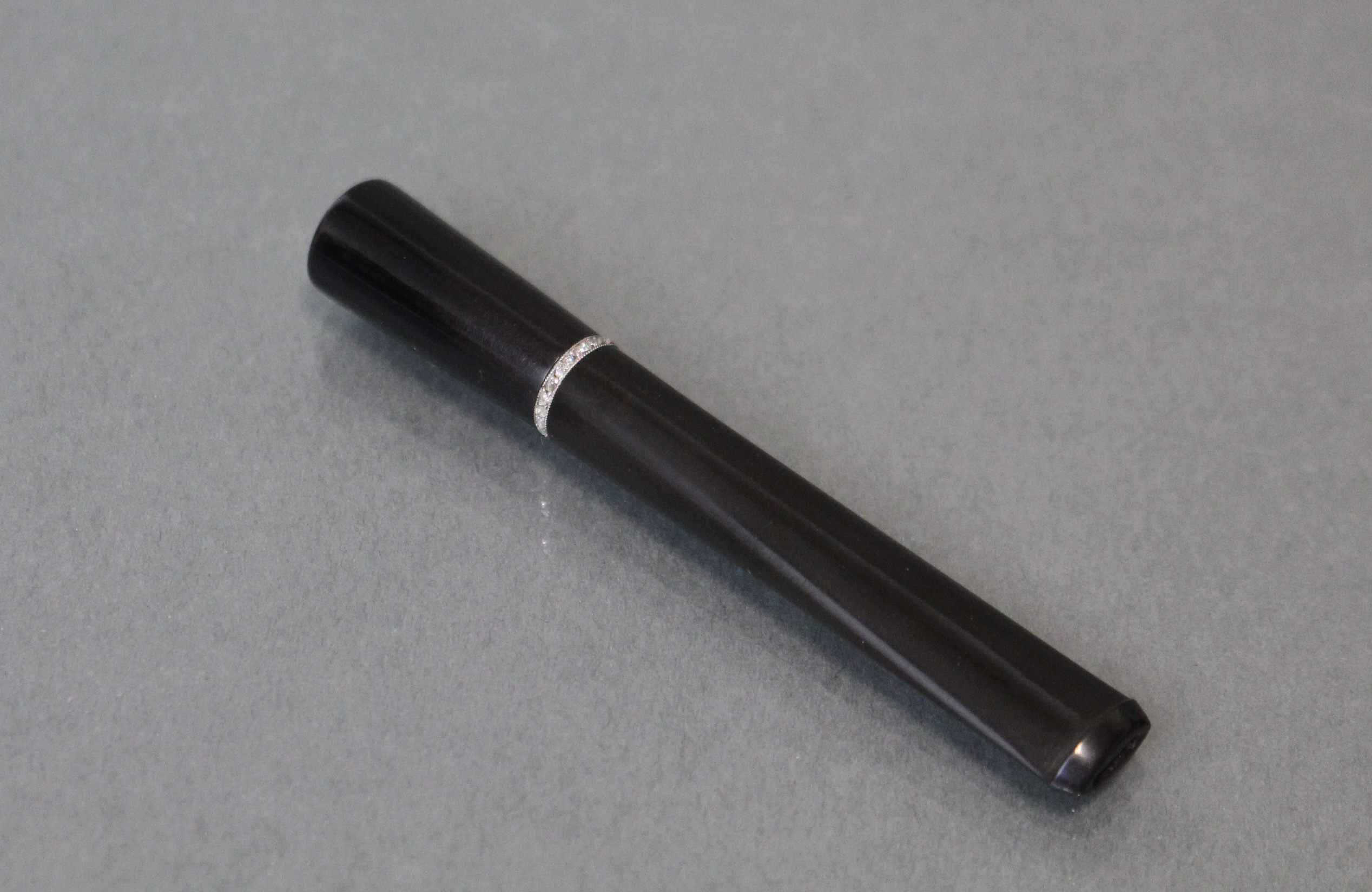 An Asprey diamond-set cigarette holder, the plain sleek black body with narrow white metal band - Image 3 of 3