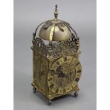 A 17th century style BRASS LANTERN CLOCK, the 6­½” engraved dial with roman numerals below a pierced