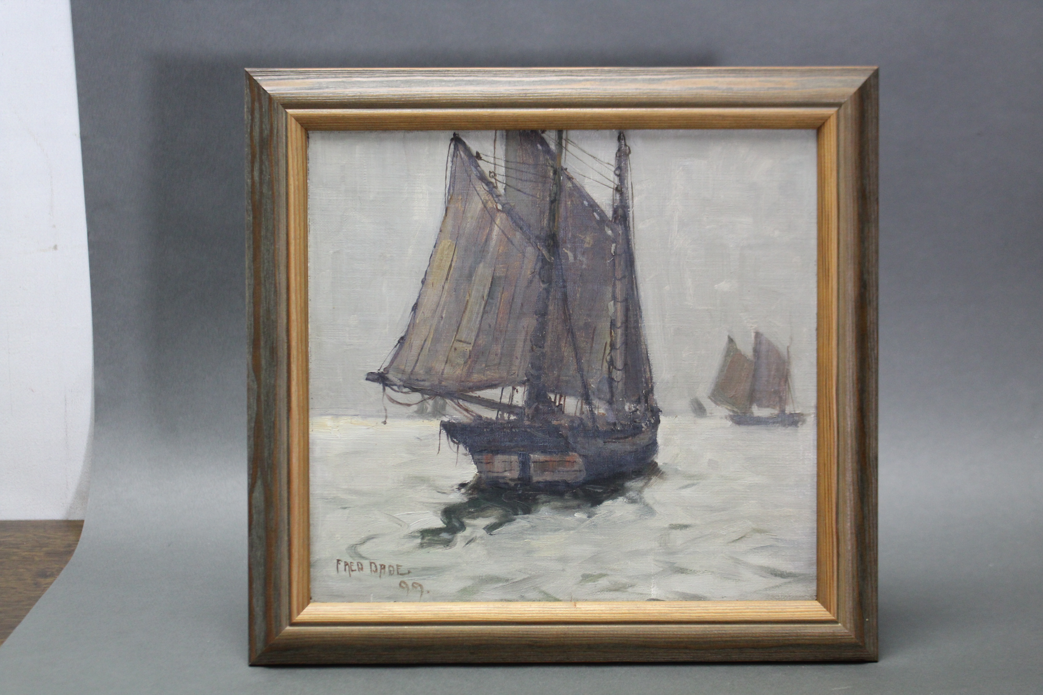FREDERICK DADE (1874-1908). A two-masted fishing vessel in calm waters, other boats beyond; oil on