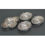 A George V silver quatre-lobe small oval dish with embossed decoration of flowers & scrolls,