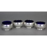 A set of four Victorian silver salt cellars, each of compressed round semi-fluted form, on rim foot,
