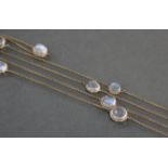 A moonstone necklace, the thirteen cabochons mounted between lengths of yellow metal fine-link