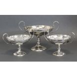 A suite of three Edwardian silver comports of tazza form, each with loop side handles to the shallow