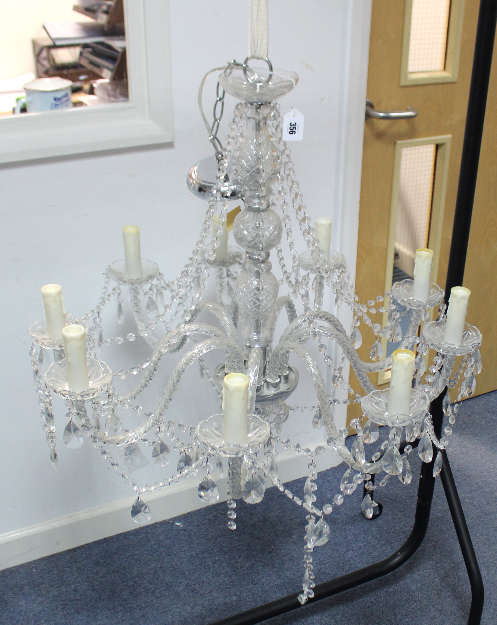 A cut-glass nine branch chandelier, with central baluster column & scroll arms, hung with beads &