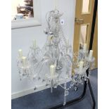 A cut-glass nine branch chandelier, with central baluster column & scroll arms, hung with beads &
